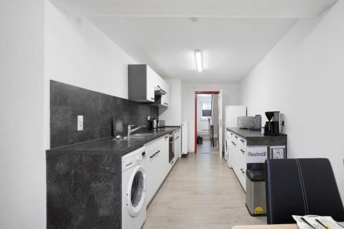 a kitchen with a sink and a washing machine at Ferienhaus Doris in Bad Urach