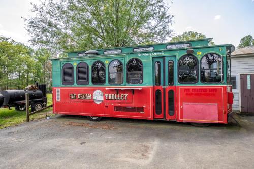 a red and green train car parked in a driveway at Hobbit House, one-of-a-kind home in Bel Air