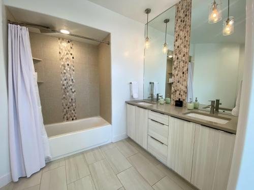 ein Bad mit einer Badewanne, einem Waschbecken und einer Dusche in der Unterkunft Timber & Tin E 2Bed 2Bath w Pool & Rooftop Deck in Kanab