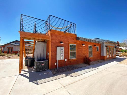 a brick building with a balcony on top of it at Timber & Tin G 2Bed 2Bath w Pool & Rooftop Deck in Kanab