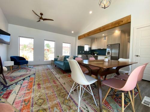 a kitchen and living room with a table and chairs at Timber & Tin E 2Bed 2Bath w Pool & Rooftop Deck in Kanab