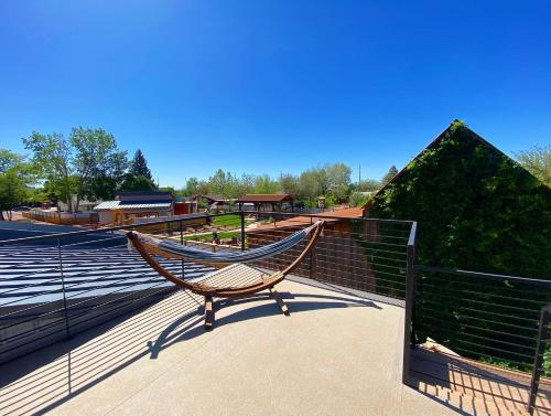a hammock sitting on the side of a deck at Timber & Tin H 2Bed 2Bath w Pool & Rooftop Deck in Kanab