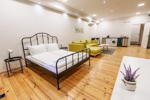a bedroom with a bed and a living room at Saffron Guest House in Plovdiv