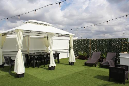 a gazebo with a table and chairs on a lawn at B&B DEGLI ANGELI in Lecce