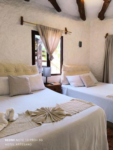 a bedroom with two beds and a window at Arte Sano Hotel Only Adults - Near Beach in Holbox Island