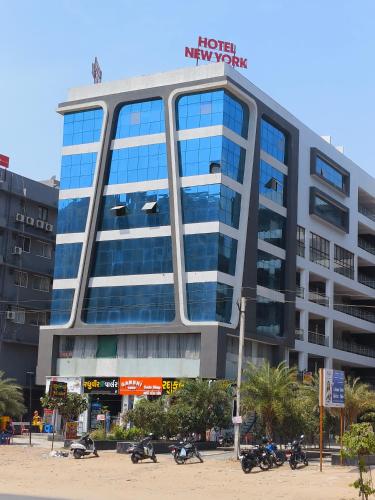 a large building with motorcycles parked in front of it at HOTEL NEW YORK in Ahmedabad