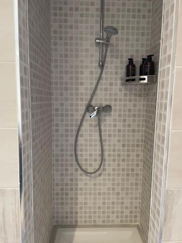 a shower with a shower head in a bathroom at Chambre emplacement idéal in Sanary-sur-Mer