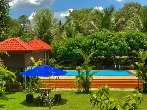 a resort with a swimming pool and a house at Yatinuwara Bungalow in Anuradhapura