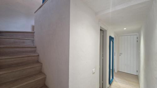 a hallway with stairs in a house at Villaggio Est a Capo Coda Cavallo San Teodoro in San Teodoro