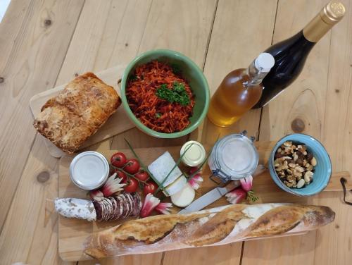 a table with a plate of food and a bottle of wine at Magnolias in Chinon