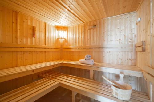 an empty wooden sauna with a bucket in it at Chalet Olbios in Peisey-Nancroix