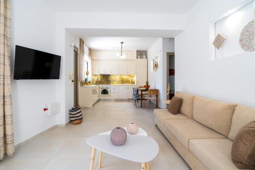a living room with a couch and a table at Sueño Seaside Residence in Agia Pelagia