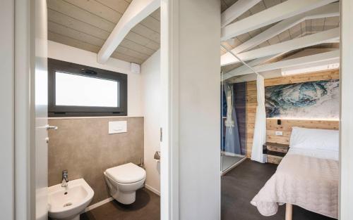 a bathroom with a bed and a toilet and a sink at Cielo&Terra Resort in Costermano