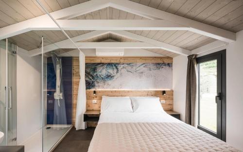 a bedroom with a large bed and a window at Cielo&Terra Resort in Costermano