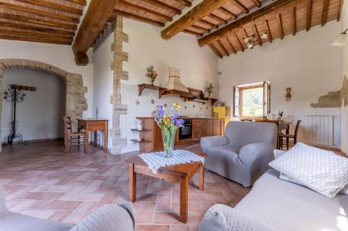 a living room with a couch and a table at Podere Marcigliana in Radicondoli