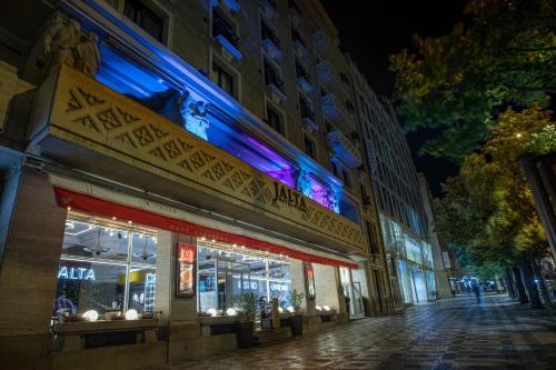 a city street at night with a store at Jalta Boutique Hotel in Prague