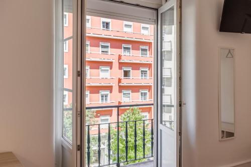 a window with a view of a building at Home Out Rooms & Apartments in Lisbon