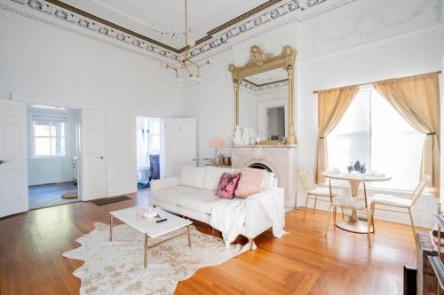 a living room with a white couch and a table at Decadent Luxury - Covington Condo in Covington