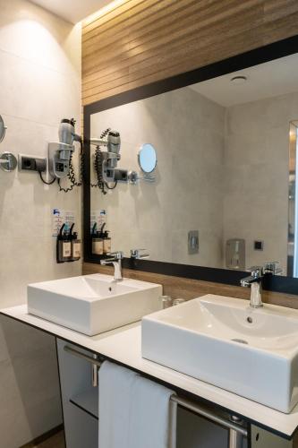 two sinks in a bathroom with a large mirror at Onmood Cala Ratjada - Bed & Brunch in Cala Ratjada