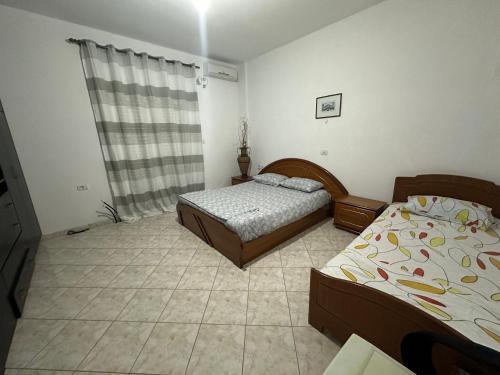 Postel nebo postele na pokoji v ubytování Guest House Ksamil
