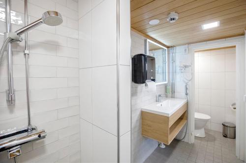 a bathroom with a sink and a shower at HOSTEL TOIVOLA in Kemi