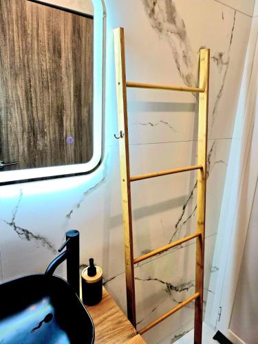 a ladder sitting next to a table with a chair at Philoxenia Guest Studio in Himare