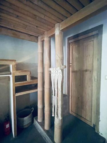 a room with a bunk bed and a wooden door at Studio On Air in Gili Islands