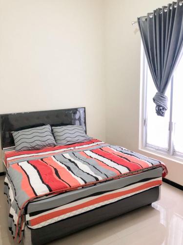 a bed sitting in a bedroom with a window at Villa risky A11 in Tlekung