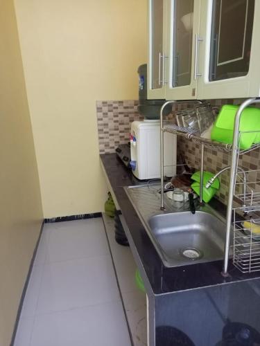 a kitchen counter with a sink and a microwave at Villa risky A11 in Tlekung