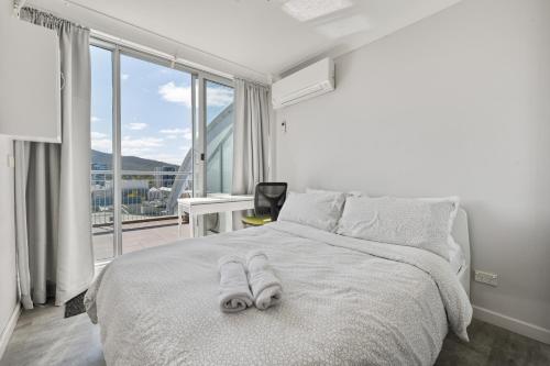 a bedroom with a bed with two towels on it at Private Room in a City Centre Duplex Apartment-3 in Canberra