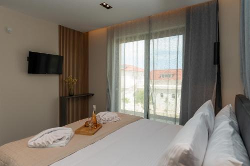 a bedroom with a bed and a large window at Villa Linea Verde I by Sealand Villas in Tsilivi