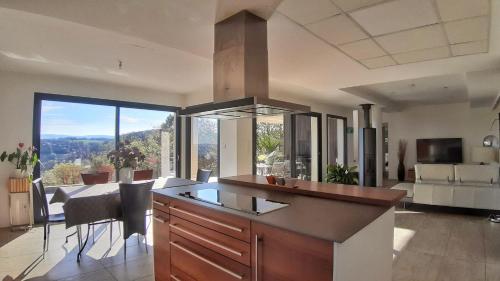 a kitchen with a view of a living room at Villa la Panoramique in Soumont