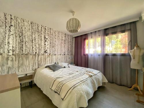 a bedroom with a large bed and a window at Villa la Panoramique in Soumont