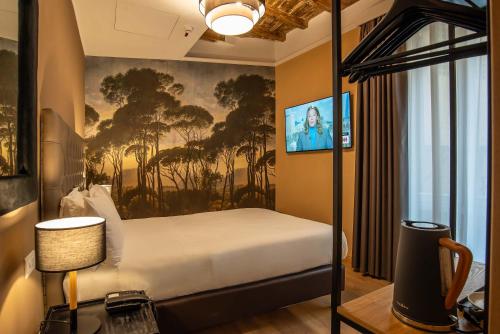 a bedroom with a bed and a painting on the wall at Hotel Elite in Rome
