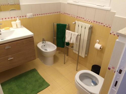 a bathroom with a toilet and a sink at Appartamento Ostia Enjoy in Lido di Ostia