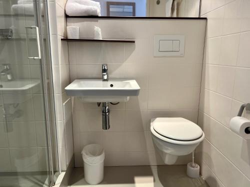 a bathroom with a toilet and a sink and a shower at Premiere Classe Le Havre Centre-LES DOCKS in Le Havre