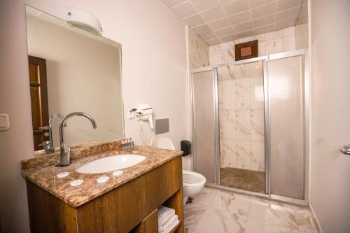 a bathroom with a sink and a toilet and a shower at Mare Blu Hotel in Trabzon