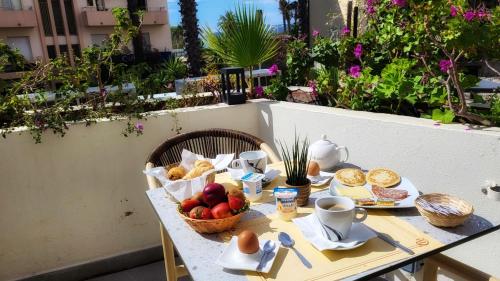 una tavola con un cesto di frutta e uova di Anglade Hotel a Le Lavandou