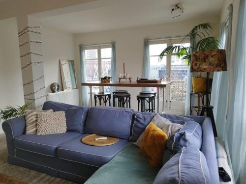 a blue couch in a living room with a table at Penthouse in hartje Enschede in Enschede