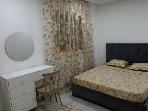 a bedroom with a bed and a dresser and a mirror at Ben arous one in Ben Arous