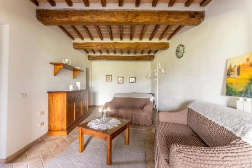 a living room with a couch and a table at Podere Marcigliana in Radicondoli