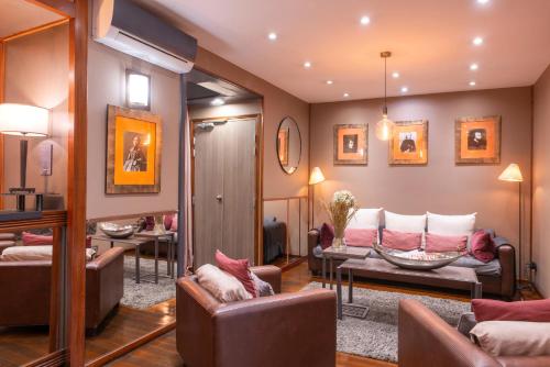 a living room with two couches and a couch at Hotel George Sand Opéra Paris in Paris