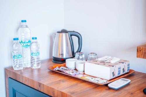 a counter with bottles of water and a coffee maker at Mysia Olympos Hotel in Bursa