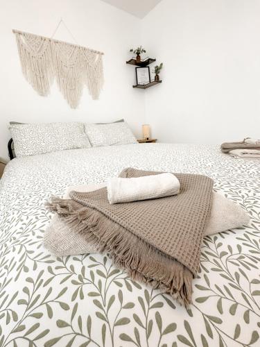 a bedroom with a bed with a blanket on it at Minimalistic apartment in Crystal Palace in Crystal Palace