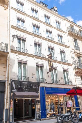 a large white building on a city street at Hotel George Sand Opéra Paris in Paris
