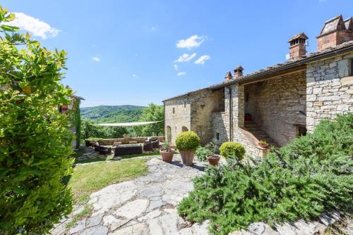 una vista esterna di un edificio in pietra con piante di Villa Cavallari a Radda in Chianti