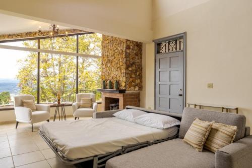 a bedroom with a bed and a fireplace at Spectacular House in Boquete w/King Beds & Hot Tub in Centro Jaramillo