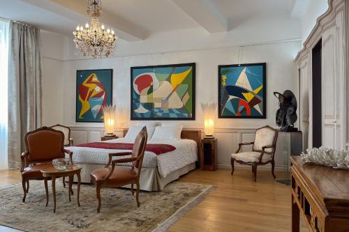 a bedroom with a bed and paintings on the wall at Chambre d'Art in Dax