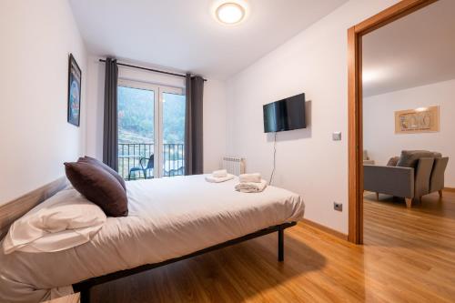 a bedroom with a bed and a large window at Apartamento TINTIN en Arinsal in Arinsal