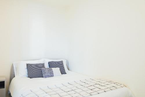 a white bed with two pillows on top of it at Oceanview Apt Near Panama City w/ King Bed & More in Playa Bonita Village